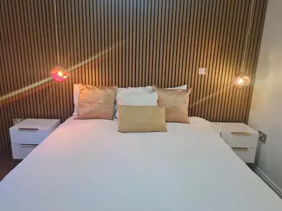 a bedroom with a large white bed with two night stands at 30 The Elms in Blackpool
