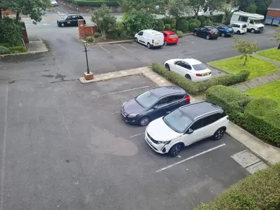 an aerial view of two cars parked in a parking lot at 30 The Elms in Blackpool