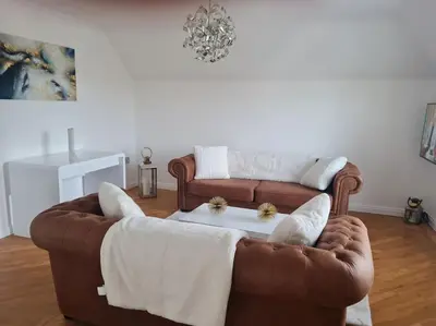 a living room with a brown couch and a table at 30 The Elms in Blackpool