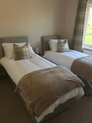 two beds sitting next to each other in a bedroom at Hamilton Hideaway between Lancaster & Morecambe in Bare