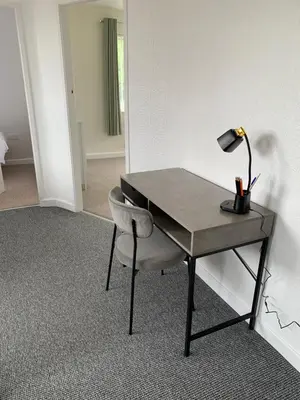 a desk with a lamp and a chair in a room at Hamilton Hideaway between Lancaster & Morecambe in Bare