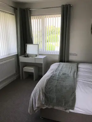 a bedroom with a bed and a desk with a computer at Hamilton Hideaway between Lancaster & Morecambe in Bare