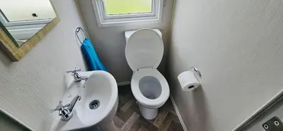 a small bathroom with a toilet and a sink at Caravan-Blackpool-FamilyFriendly-Activities in Fleetwood