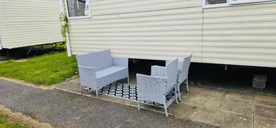 two chairs and a table in front of a house at Caravan-Blackpool-FamilyFriendly-Activities in Fleetwood