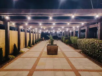 a walkway with lights and a potted plant on it at Caravan-Blackpool-FamilyFriendly-Activities in Fleetwood