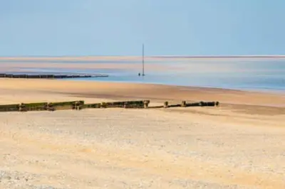 a beach with a pier in the middle of the water at Caravan-Blackpool-FamilyFriendly-Activities in Fleetwood