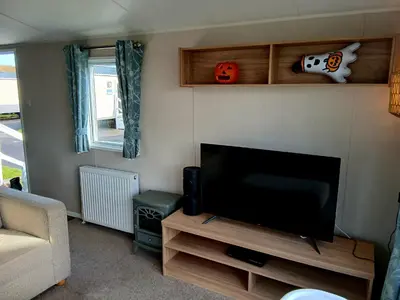 a living room with a flat screen tv and a couch at Caravan-Blackpool-FamilyFriendly-Activities in Fleetwood