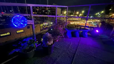 a view of a city at night with purple lights at Float uniquely on Liverpool Waterfront on our high end 8 berth Houseboat in Liverpool