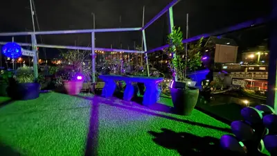 a view of a patio at night with purple lights at Float uniquely on Liverpool Waterfront on our high end 8 berth Houseboat in Liverpool
