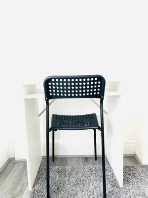 a black chair sitting in front of a desk at Walton Breck Road, Anfield LFC in Liverpool