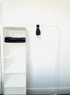 a white book shelf next to a white wall at Walton Breck Road, Anfield LFC in Liverpool