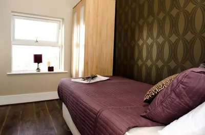 a small bedroom with a bed and a window at Trivelles Liverpool in Liverpool