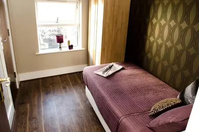 a small bedroom with a bed and a window at Trivelles Liverpool in Liverpool