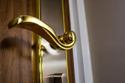 a gold door knob on a door with a door at Trivelles Liverpool in Liverpool