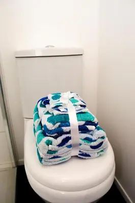 a towel sitting on top of a toilet in a bathroom at Trivelles Liverpool in Liverpool
