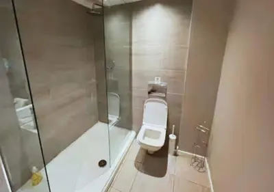 a bathroom with a toilet and a glass shower at Heritage Bank Liverpool Near Cavern sleeps 3 in Liverpool