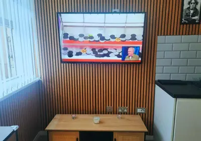 a kitchen with a table and a picture on the wall at Heritage Bank Liverpool Near Cavern sleeps 3 in Liverpool