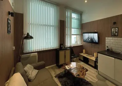 a living room with a couch and a tv at Heritage Bank Liverpool Near Cavern sleeps 3 in Liverpool