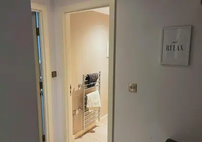 a door leading to a bathroom with a mirror at Heritage Bank Liverpool Near Cavern sleeps 3 in Liverpool