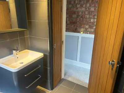 a bathroom with a sink and a shower at Entire Seaside Home 6 Private BedRooms Sleeps 10,4 Minute Walk To Station in New Brighton