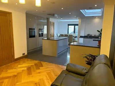 a living room with a couch and a kitchen at Entire Seaside Home 6 Private BedRooms Sleeps 10,4 Minute Walk To Station in New Brighton