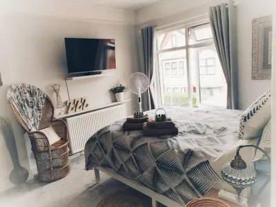 a bedroom with a bed and a table and a window at Aqua View, New Brighton Beach - 1 bedroom with BALCONY & VIEW in New Brighton