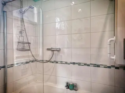 a shower with a glass door in a bathroom at Aqua View, New Brighton Beach - 1 bedroom with BALCONY & VIEW in New Brighton