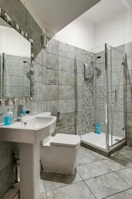 a bathroom with a sink and a toilet and a shower at 9 Rodney Townhouse in Liverpool