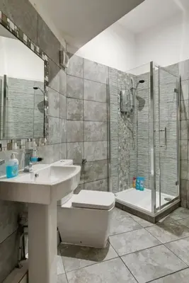 a bathroom with a sink and a toilet and a shower at 9 Rodney Townhouse in Liverpool