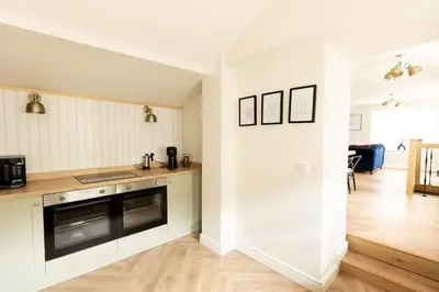 a kitchen with white cabinets and a counter top at OLD BANK HOUSE - Perfect Getaway for Friends & Families in Holker
