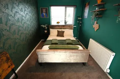 a bedroom with a bed in a green wall at Detached Homestay - Super, King & Double Rooms - Leyland, Preston, Chorley, Lancashire in Leyland