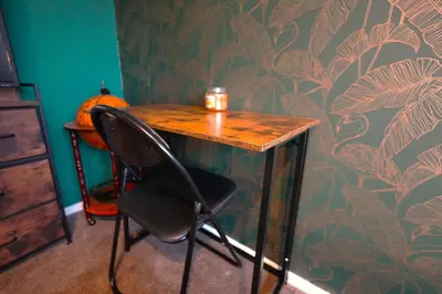 a desk with a chair and a pumpkin on a wall at Detached Homestay - Super, King & Double Rooms - Leyland, Preston, Chorley, Lancashire in Leyland