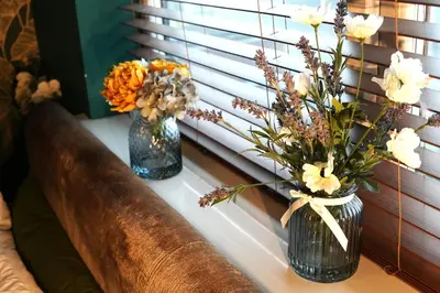 three vases with flowers sitting on a window sill at Detached Homestay - Super, King & Double Rooms - Leyland, Preston, Chorley, Lancashire in Leyland