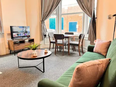 a living room with a couch and a table at Apartment 1 in Blackpool
