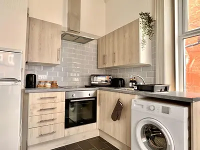 a kitchen with a washer and a washing machine at Apartment 1 in Blackpool