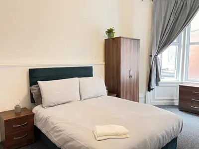 a bedroom with a bed with a towel on it at Apartment 1 in Blackpool