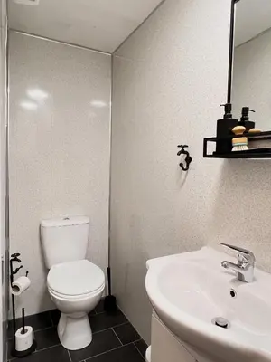 a bathroom with a white toilet and a sink at Apartment 1 in Blackpool