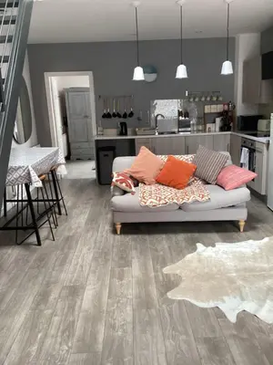 a living room with a couch and a kitchen at 2 bedroom apartment in Horwich