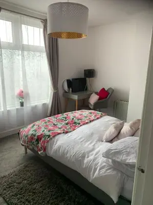 a bedroom with a bed and a window at 2 bedroom apartment in Horwich