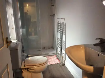 a bathroom with a toilet and a sink and a shower at 2 bedroom apartment in Horwich