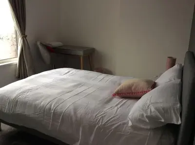 a bed with two pillows on it in a bedroom at 2 bedroom apartment in Horwich