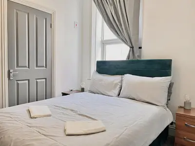 a bedroom with a large bed with two towels on it at Apartment 2 in Blackpool