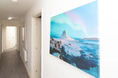 a hallway with a wall mural of a mountain at City Haven Modern 3 Bedroom Apartment with Private Parking in Liverpool