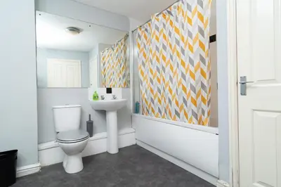 a bathroom with a toilet and a sink at City Haven Modern 3 Bedroom Apartment with Private Parking in Liverpool