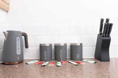 a kitchen counter with four appliances on a counter top at City Haven Modern 3 Bedroom Apartment with Private Parking in Liverpool