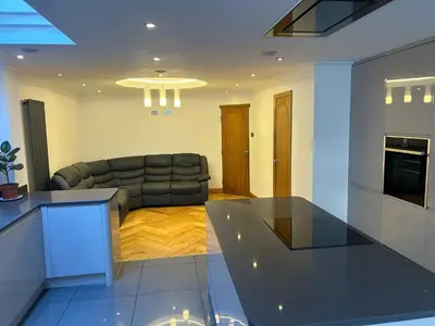 a living room with a couch and a table at Entire Seaside Home 6 Private Bedrooms Sleeps 10 in Wallasey