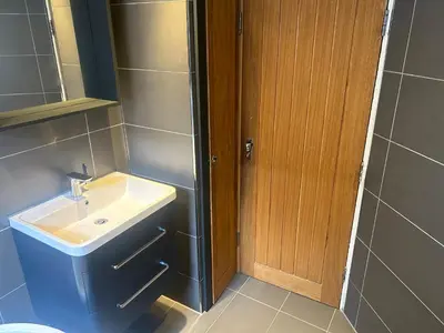 a bathroom with a sink and a toilet at Entire Seaside Home 6 Private Bedrooms Sleeps 10 in Wallasey