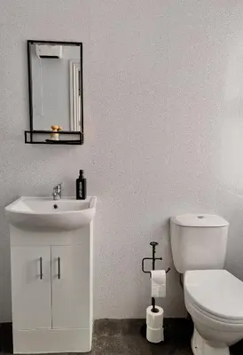 a bathroom with a white toilet and a sink at Apartment 3 in Blackpool