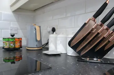 a kitchen counter with knives on a counter top at Modern Retreat Your Birkenhead Heaven, A Peaceful Getaway in Birkenhead
