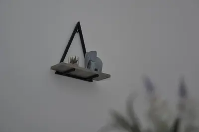 a small plant in a pot in a hanging holder at Modern Retreat Your Birkenhead Heaven, A Peaceful Getaway in Birkenhead